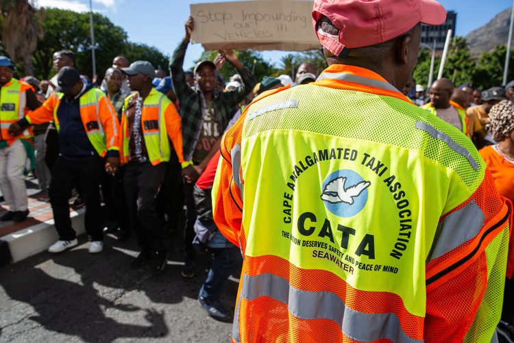 A member wears a Cape Amalgamated Taxi Association (CATA) during a protest in Cape Town. - Ashraf Hendricks