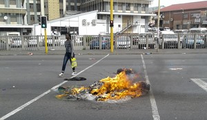 Photo of burning tyres in a street.