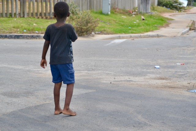 Photo of a boy standing in the road