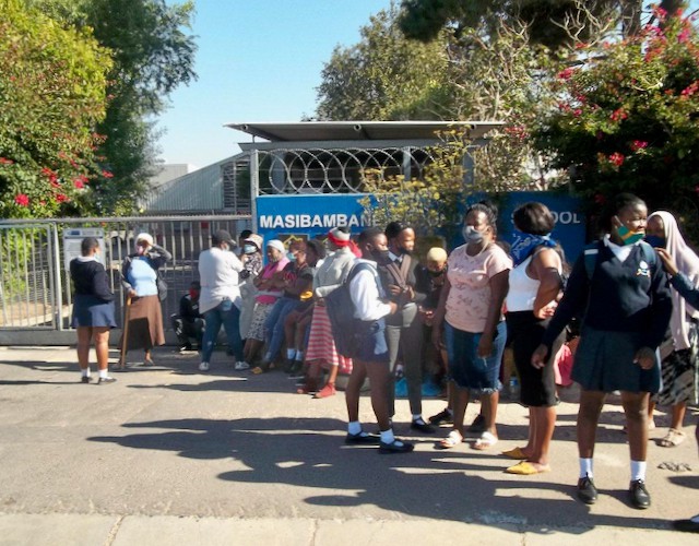 Photo of parents and learners outside a school