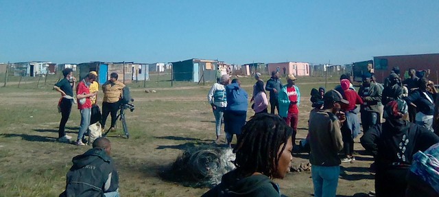 Photo of people and shacks