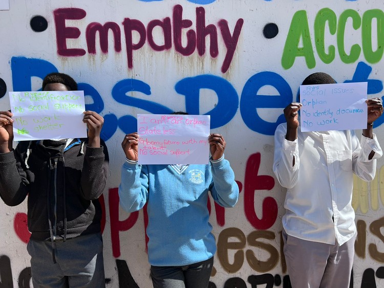 Photo of children (with faces obscured) protesting 