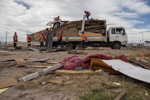 Photo of housing materials being loaded onto a truck