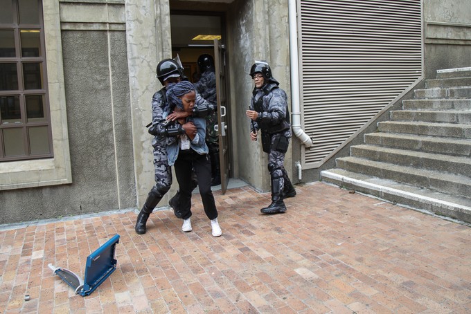 Photo of security guards holding woman