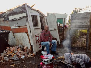 Photo of a man outside a shack
