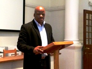 Photo of a man giving a speech at a podium