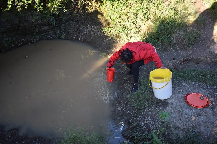 Photo of  Nwabisa collecting water