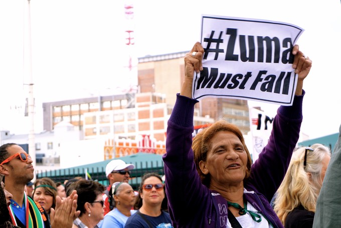 Photo of woman holding Zuma Must Fall placard