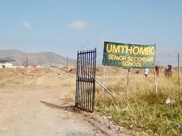 Photo of a school gate and sign