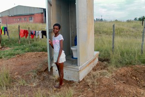 Photo of a child next to a toilet