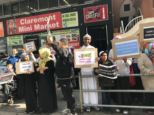 Photo of people standing with placards
