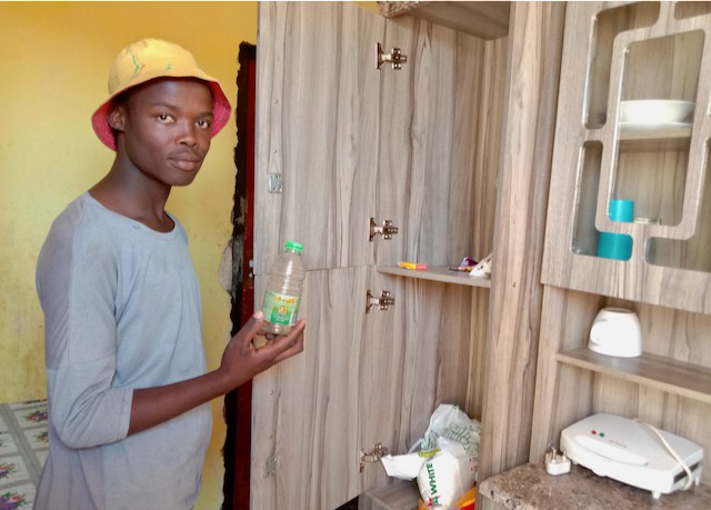 Photo of a man holding an empty bottle