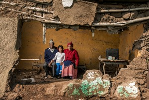 Photo of family in broken hut