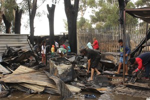 Photo residents looking through charred belongings