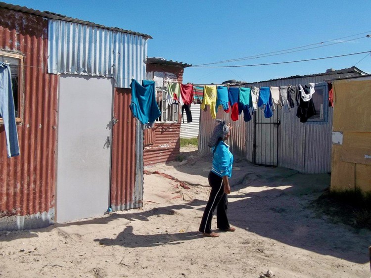 Photo of a woman outside a shack