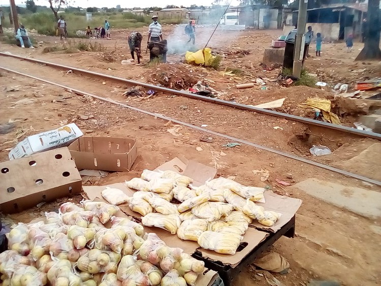 Traders are selling goods on the railway tracks in ...