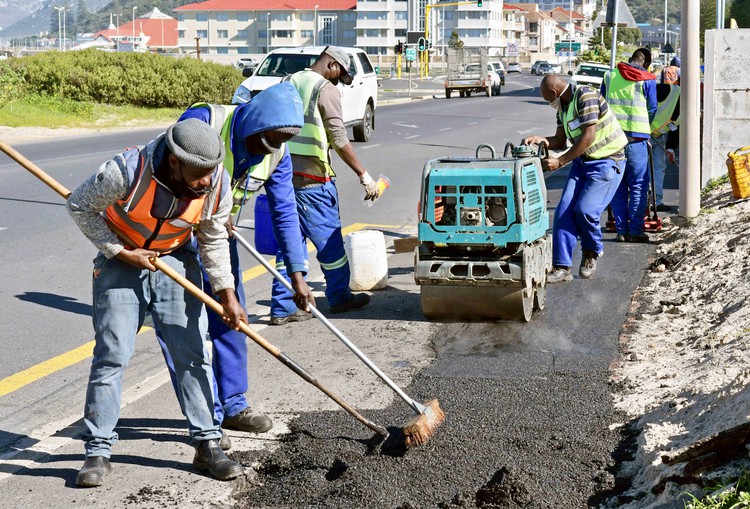 Photo of men working on a pavement