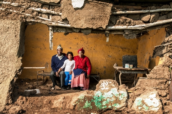 Photo of family in broken down house